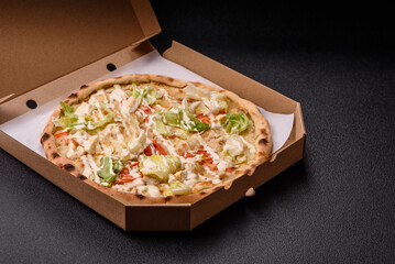 Italian caesar pizza with cheese and chicken, lettuce leaves and sauce