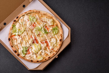 Italian caesar pizza with cheese and chicken, lettuce leaves and sauce