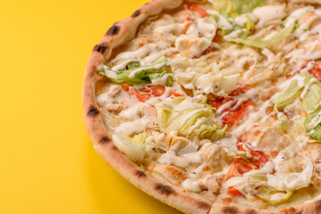 Italian caesar pizza with cheese and chicken, lettuce leaves and sauce