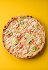 Italian caesar pizza with cheese and chicken, lettuce leaves and sauce