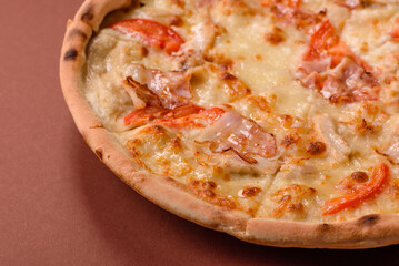 Italian pizza with chicken and bacon, cheese, tomatoes and sauce