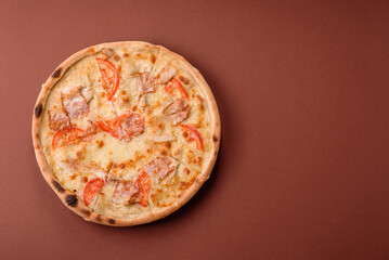 Italian pizza with chicken and bacon, cheese, tomatoes and sauce