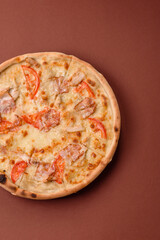 Italian pizza with chicken and bacon, cheese, tomatoes and sauce