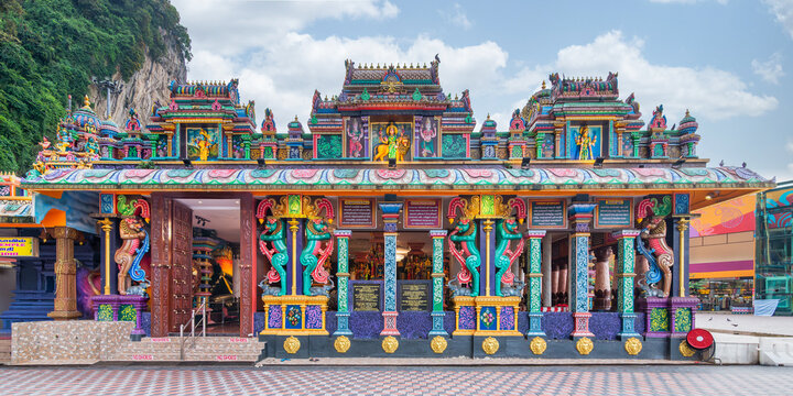 Kuala Lumpur, Malaysia - February 18, 2025: Ornate Sri Maha Mariamman temple at the famous Batu Caves religious site. Colorful architecture against limestone cliffs