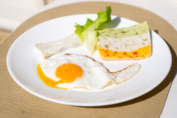 Fototapeta premium Gourmet breakfast plate with fried egg and vegetable terrine