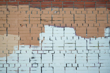 Fototapeta premium Brick wall painted with stripes of paint.