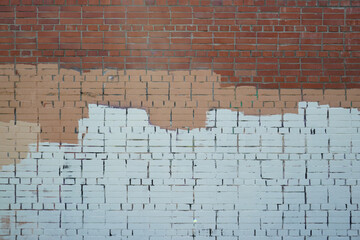 Brick wall painted with stripes of paint.