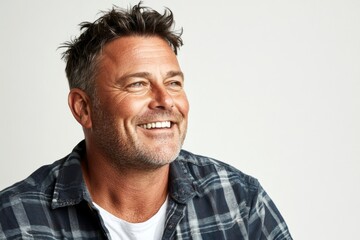 Obraz premium Pure white solid background. Creative visual design of style for aging men. Fashionable men's side part haircut - midlife white man with hair. A happy and poised man radiating charm.