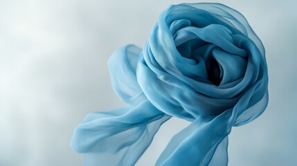 Elegantly draped blue silk fabric in soft flowing motion