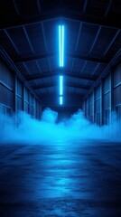 Misty blue light fills an empty warehouse creating a surreal atmosphere at night