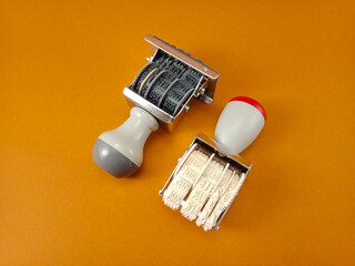 Two rubber date stamps on light brown background