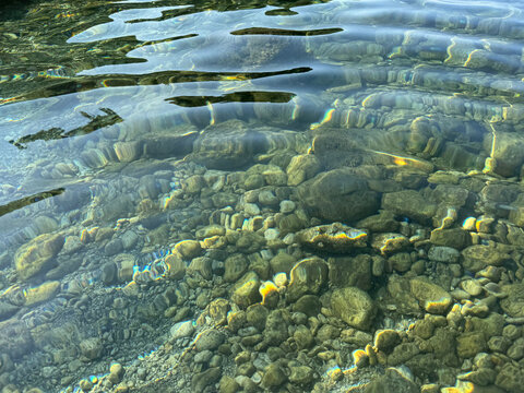 Crystal clear sea water with pebbles and stones.