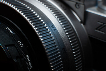 Close-up macro shot of retro style camera controls. Silver camera controls in soft focus