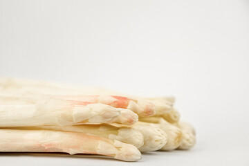White asparagus close-up on a white background. Asparagus advertising