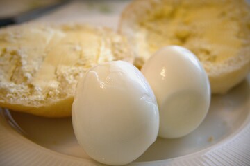 Two boiled eggs with bun and margarine