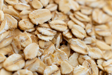 Close-up macro shot of raw oat flakes in shallow depth of field