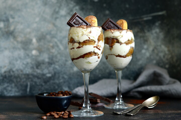 Delidious italian dessert - tiramisu with chocolate in a glasses .
