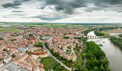 Aerial view of the medieval bridge and city of Tordesillas in Valladolid by the Douro River.