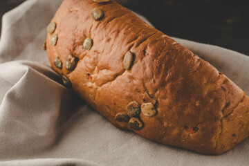 Pumpkin and carrot bread on grey towel on dark background