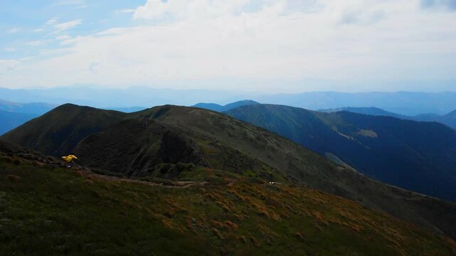 Aerial: Drone Panning Beautiful Shot Of Person Running On Hills Against Cloudy Sky - Eastern Beskids, Ukraine