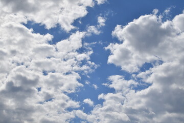 Blue sky with rays of sunshine and beautiful white clouds