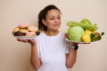 Woman Balancing Healthy Foods and Sweet Treats in Both Hands