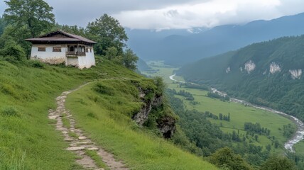 Obraz premium Scenic Mountain Monastery on a High Cliff overlooking a Lush Green Valley