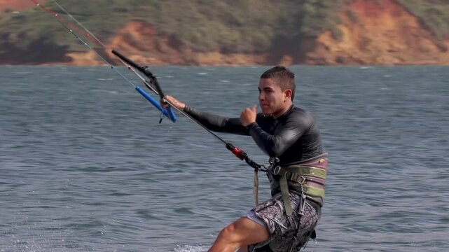 young man kitesurfing in lake calima colombia