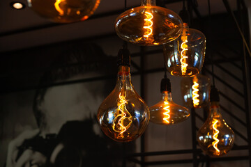 Decorative incandescent lamps suspended from the ceiling and glowing in the dark.