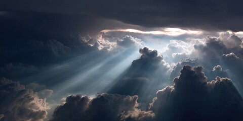 Obraz premium Heavenly rays of light pierce through a dramatic, dark sky filled with fluffy clouds. A breathtaking view from above.