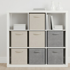 Fabric storage cubes on a minimalist white bookshelf, organized and neutral color palette