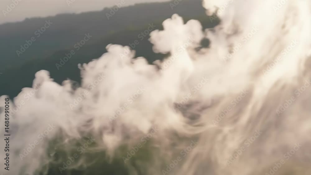 Poster overhead aerial view of dense fog over mountainous landscape with trees and green foliage, creating 