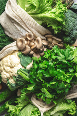 Fresh Food Background. Reusable Eco Fabric Bags for Storage with Green Vegetables, Cabbage Broccoli, Avocado, Mushrooms on Gray Table, Top View