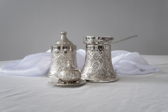 Traditional Coffee Set with Ornate Silver Pot and Cups

