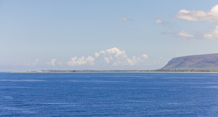 Scenic View of Kauai Coastline with Blue Ocean Waters and Clear Sky