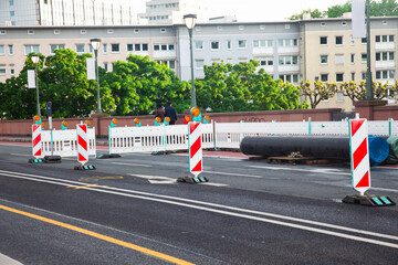 Repair of a road in the city. There are warning signs on the road.