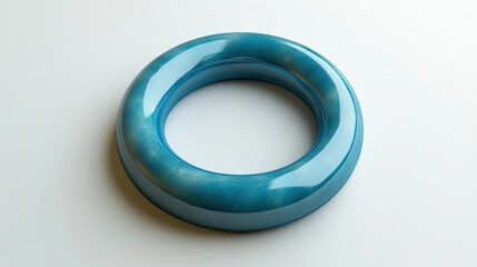 A glossy, teal-colored, circular, smooth,  decorative object,  placed on a plain background.