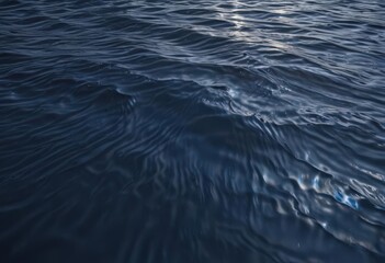 Naklejka premium Dark, deep blue surface ripples above, sunlight fading , underwater, ocean waves