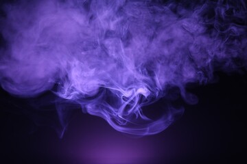 Beautiful smoke in purple light on dark background