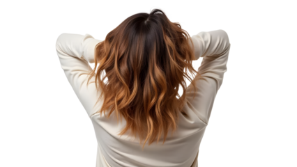 A woman with wavy, shoulder-length hair in a light-colored sweater, relaxing with her hands behind her head against a neutral background