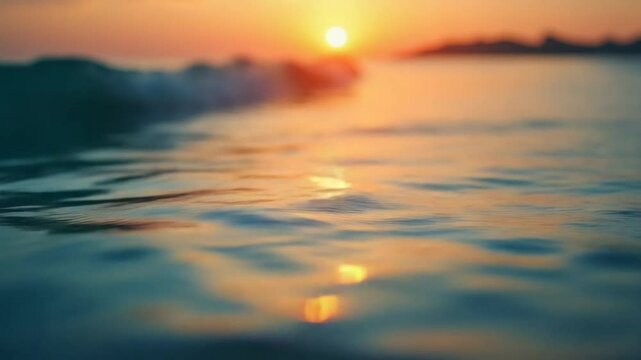 Abstract aerial sea summer ocean sunset nature background. Small waves on calm water surface in motion blur with golden bokeh lights from sun. Holiday, vacation and recreational concept. Slow motion
