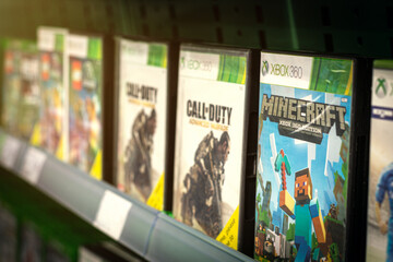 Fototapeta premium XBox 360 game selection for sale on retail shelf. Includes popular new titles Minecraft and Call of Duty Advanced Warfare for the home video game console deeloped by Microsoft.