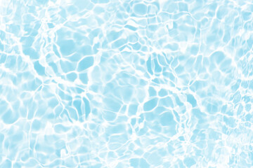 Blue water with ripples on the surface. Defocus blurred transparent blue colored clear calm water surface texture with splashes and bubbles. Water waves with shining pattern texture background.