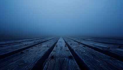 Obraz premium Foggy Landscape With Weathered Wooden Planks Leading Into Mist