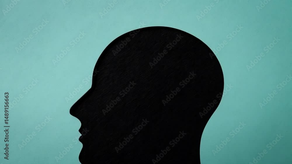 Aufkleber black head silhouette with puzzle pieces forming brain on a teal background flat lay view