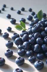 Fresh Blueberries with Leaves on Light Background

