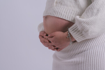 Motherhood concept Mid-section portrait of unrecognizable woman during last months of pregnancy...