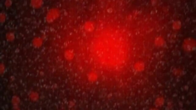 Blurred red abstract background of bokeh and small round particles of energy magical holiday flying dots on a black background