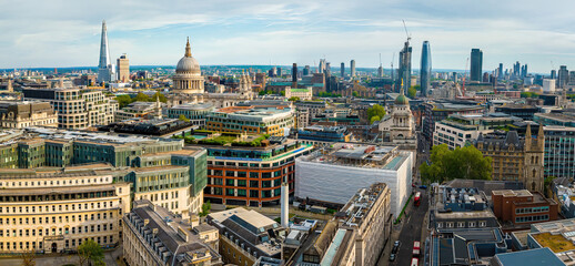 Aerial view of St. Paul's Cathedral and the surrounding modern and historic architecture in central London on a sunny day