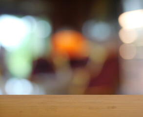 Empty brown wooden table surface for product placement with bokeh from indoor lighting in background, Blue and yellow circles spread on green and blackt colored surface of night city light